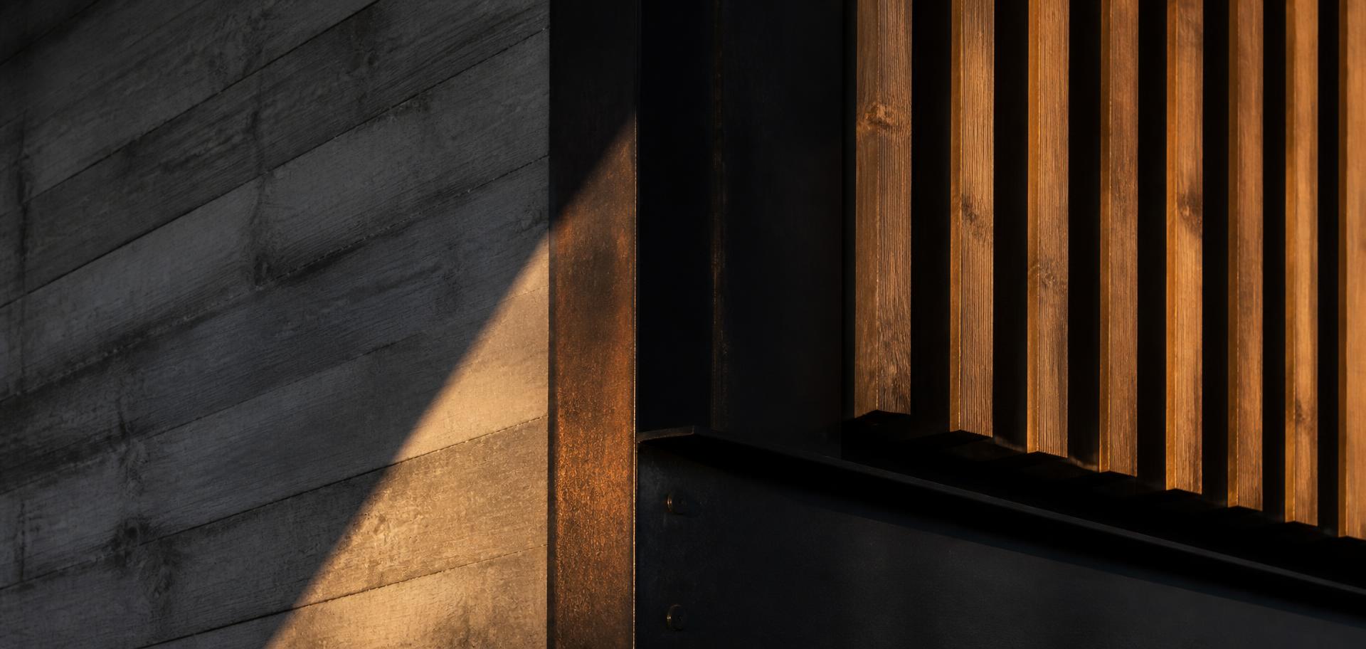 Steel, concrete and timber detail in raking light